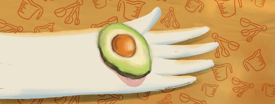 An outstretched hand holds half of an avocado, demonstrating portion control.