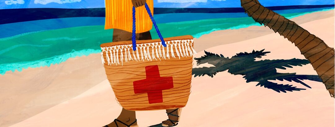 A woman walks down the beach holding a beach bag with a red cross on it.